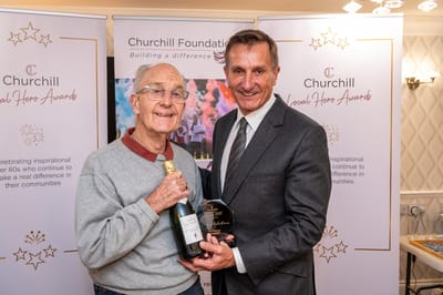 Resident receiving an award with staff member