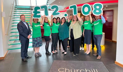 Staff celebrating a fundraising milestone inside the facility.
