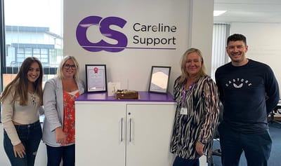 Group of staff celebrating with a cake