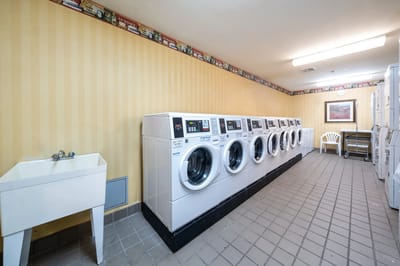Laundry room with washing machines and a sink