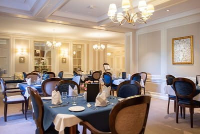Elegant dining room with neatly set tables.