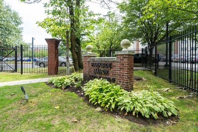Entrance sign of Parkside Manor with landscaping.
