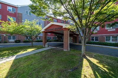 Entrance area of Parkside Manor surrounded by greenery.