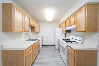 Bright kitchen with wooden cabinets and appliances