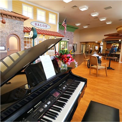 Interior view of a salon area with piano and residents.