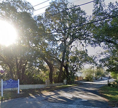 Entrance of a facility with trees and sunlight