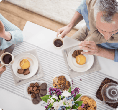 Residents enjoying coffee and pastries at a table