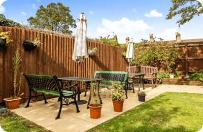 Outdoor seating area with chairs and plants