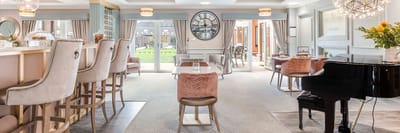 Elegant common area with seating and piano.