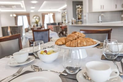 Dining area with pastries and fruit on a table
