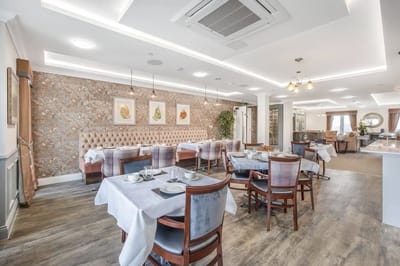 Bright dining area set for meals in a senior living facility