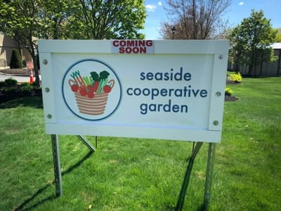 Sign for the Seaside Cooperative Garden outside