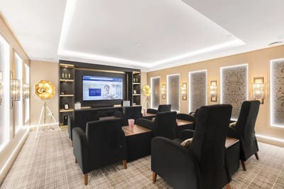 A cozy common area with comfortable seating and a TV