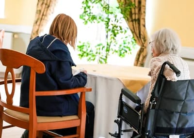 Two residents engaged in conversation in a common area