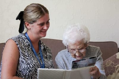 Staff member sharing a photo album with a resident
