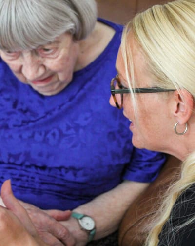 Resident and staff member engaged in conversation