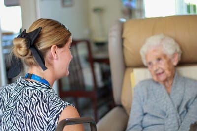 Caregiver conversing with an elderly resident