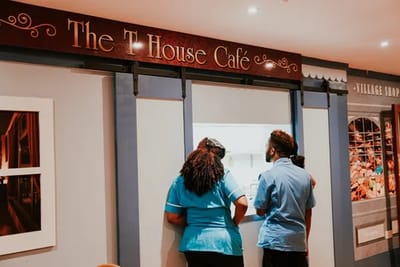 Staff members at the café counter in an indoor setting
