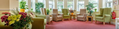 Bright common area with comfortable seating and plants