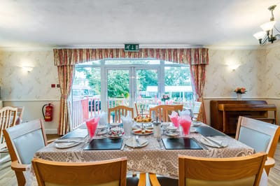 Well-set dining table with floral décor in a bright dining room