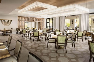 Bright and spacious dining room with tables and chairs