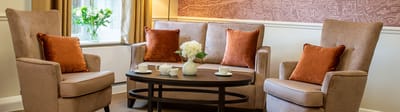 Cozy seating area with decorative pillows and flowers