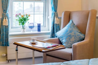 Comfortable chair in a well-decorated room with flowers
