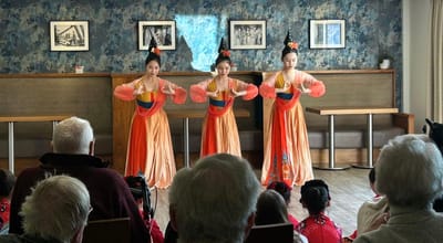 Residents enjoying a cultural performance inside the facility