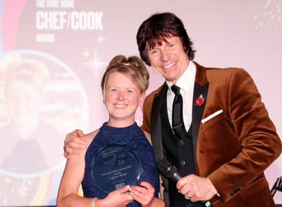 An award ceremony with a presenter and winner