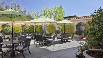 Outdoor patio area with umbrellas and seating