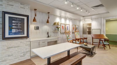 Bright and modern activity room with art and furniture