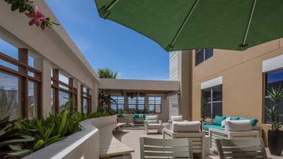 Comfortable outdoor seating area with green umbrella