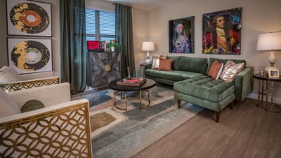 Stylish interior lounge area with green sofa and artwork