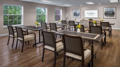 Bright and clean common area with tables and chairs