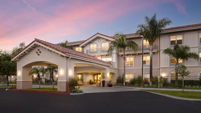 Exterior view of the Belmont Village facility at dusk
