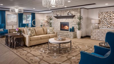 Bright common area with cozy seating and fireplace
