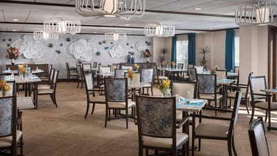 Brightly lit dining room with elegant decor and seating