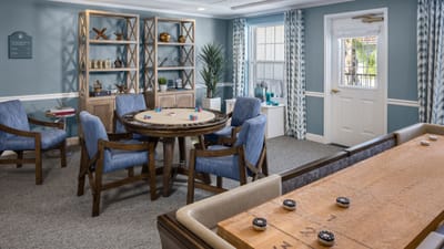 Bright activity room with a gaming table and seating