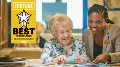 A smiling resident engaging with a staff member