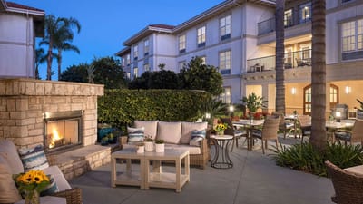 Outdoor lounge area with seating and fireplace