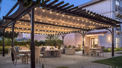 Outdoor dining area with seating and lights