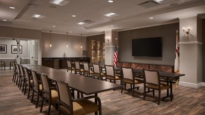 Bright common area with tables and chairs arranged