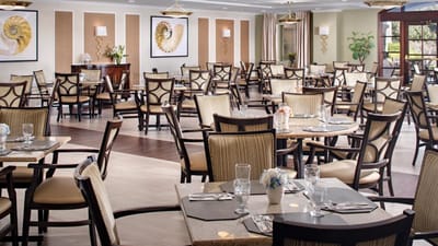 Elegant dining room with tables set for meals