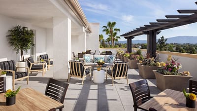 Outdoor seating area with plants and mountain view