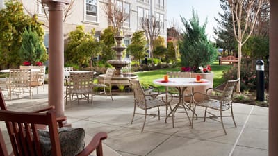 Outdoor patio with tables and seating in a garden