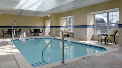 Indoor pool area with seating around it