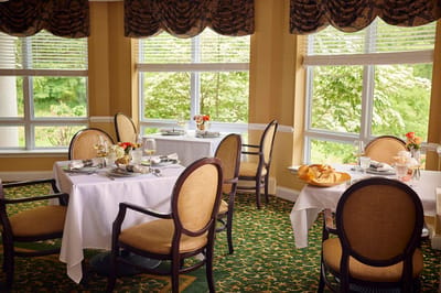 Cozy dining room with elegantly set tables and natural light