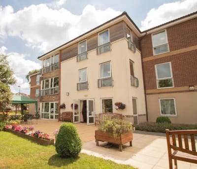 Outdoor view of Avon Lodge building with garden