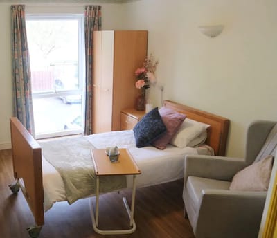 Private resident room with bed and chair