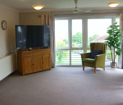 Bright common area with a television and seating